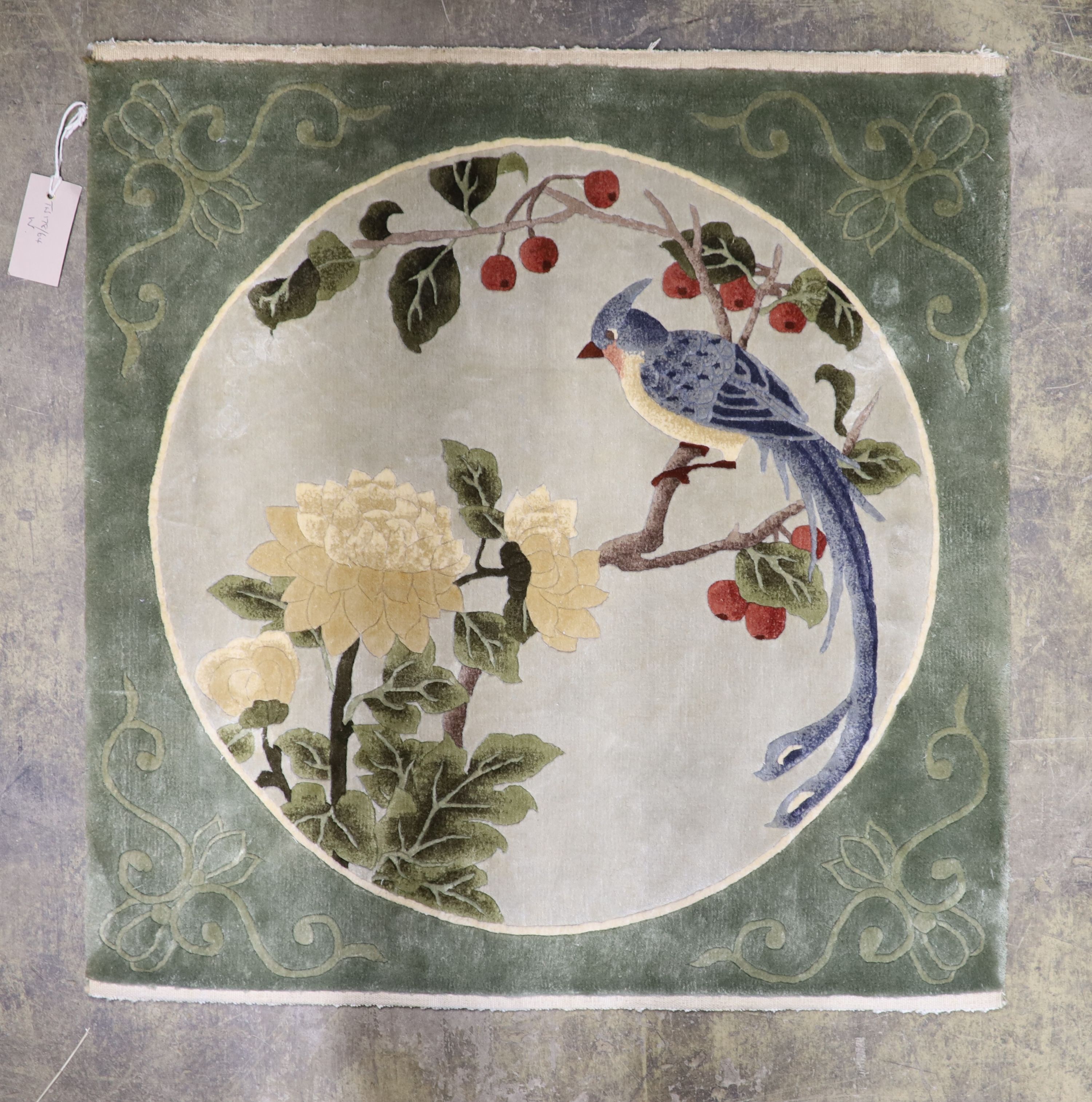 A Chinese washed and embossed panel depicting birds amongst prunus and cherries